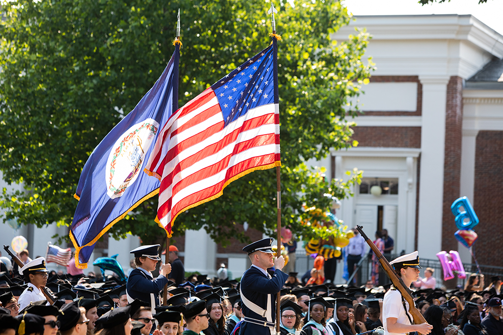 Military students walking the Virginia and US Flags at Graduation