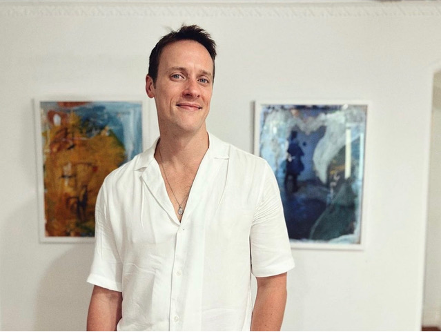 Sean Hemeon with his paintings