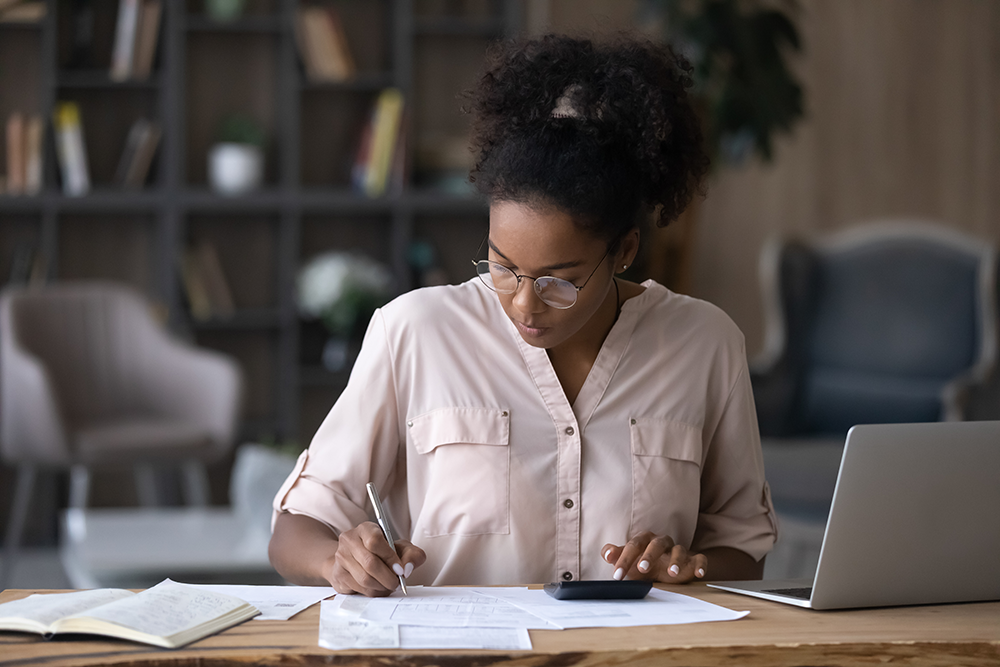 Person reviewing papers on desk