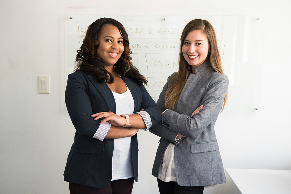 Two professional women smiling