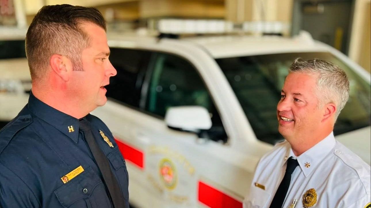 Captain Ryan Hutchison (left) talks with a fellow law enforcement professional.