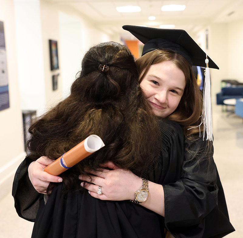 Yang and Mendoza McCall hug after graduation
