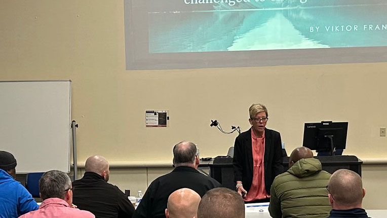 Beth Coleman teaches in front of a classroom of students.