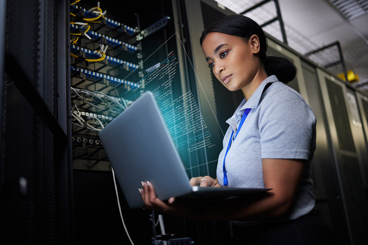 female IT technician looks at computer