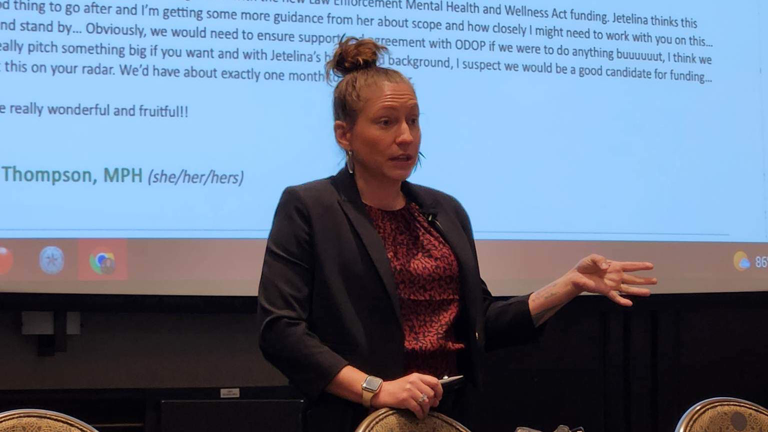 Ashley Griffin lectures during a panel presentation.