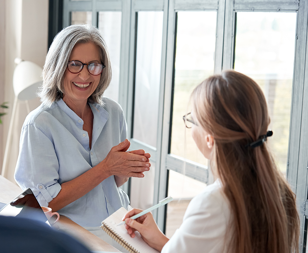 older professional female talks with younger female