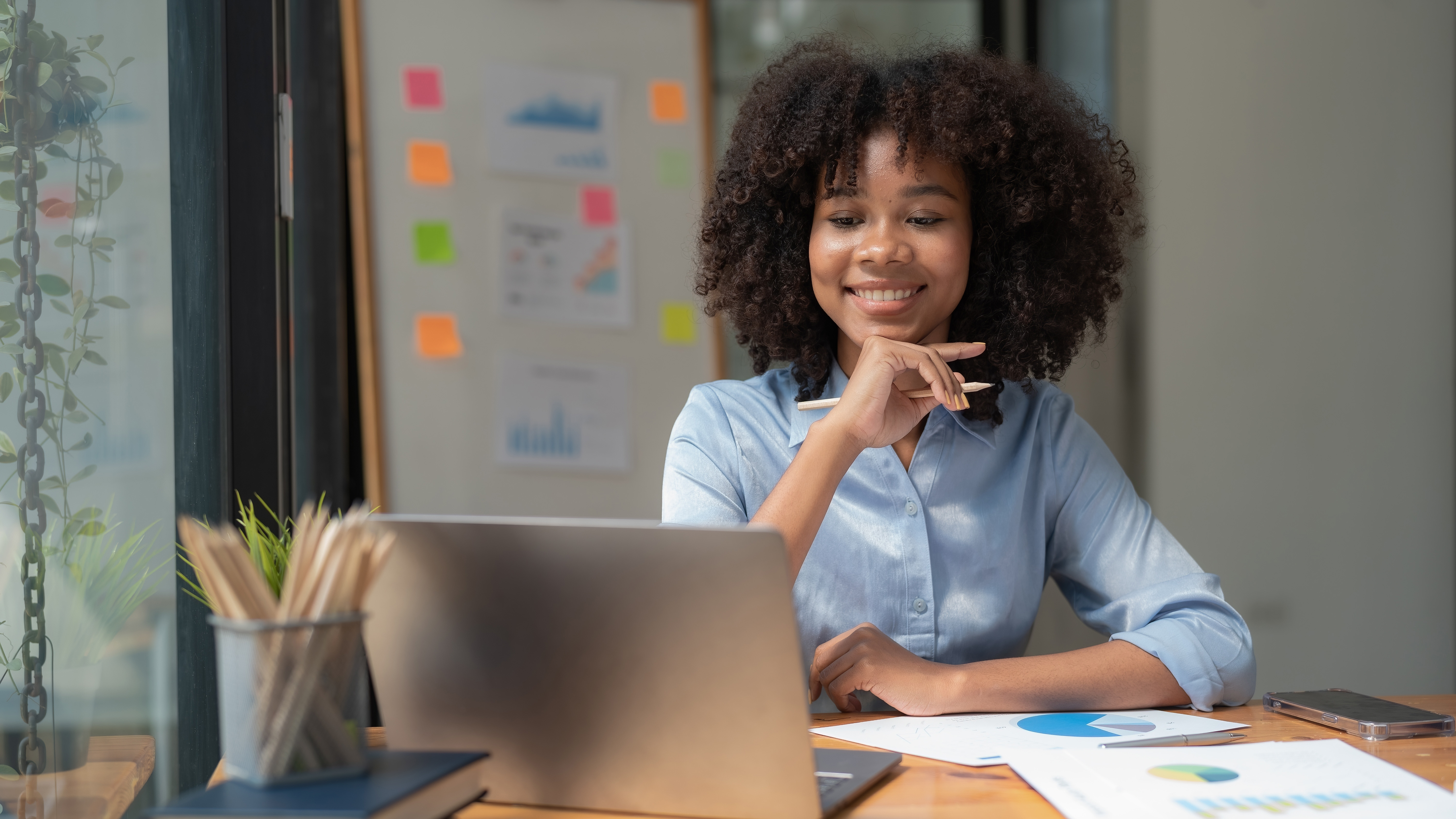 A female adult student sits in front of her laptop.