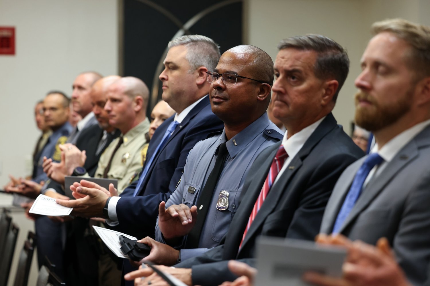 Men in a row clapping