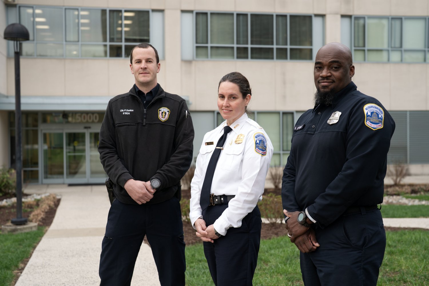 Officer Donlan, Captain Monahan, and Officer D'Abreu stand next to one another.