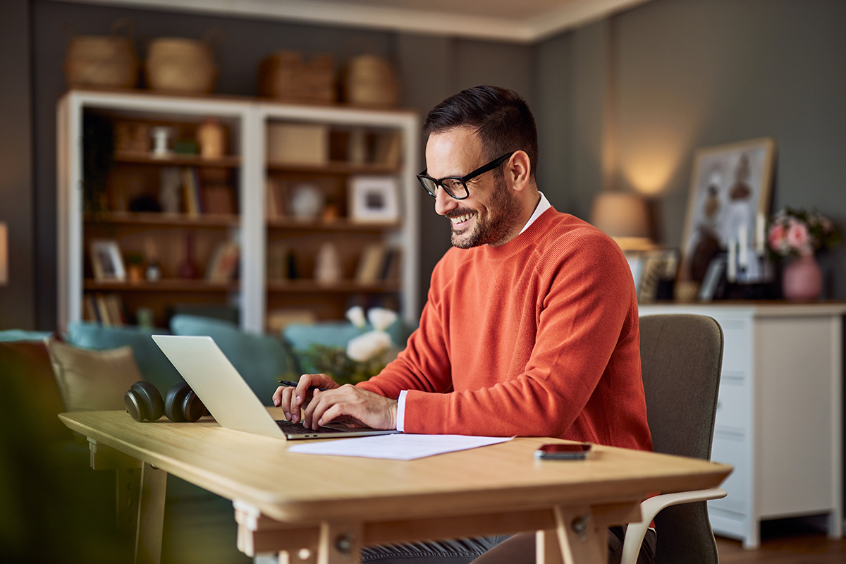 man on computer smiling at home